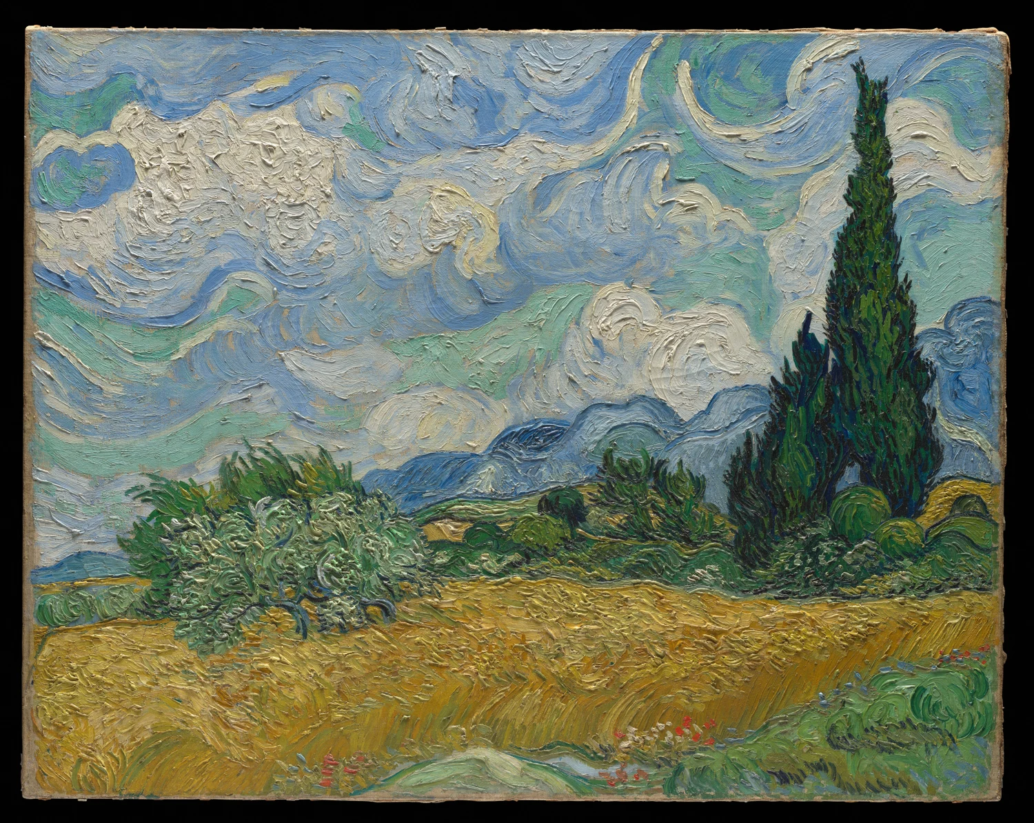 A golden wheat field, dark cypress trees and a swirling cloudy sky
